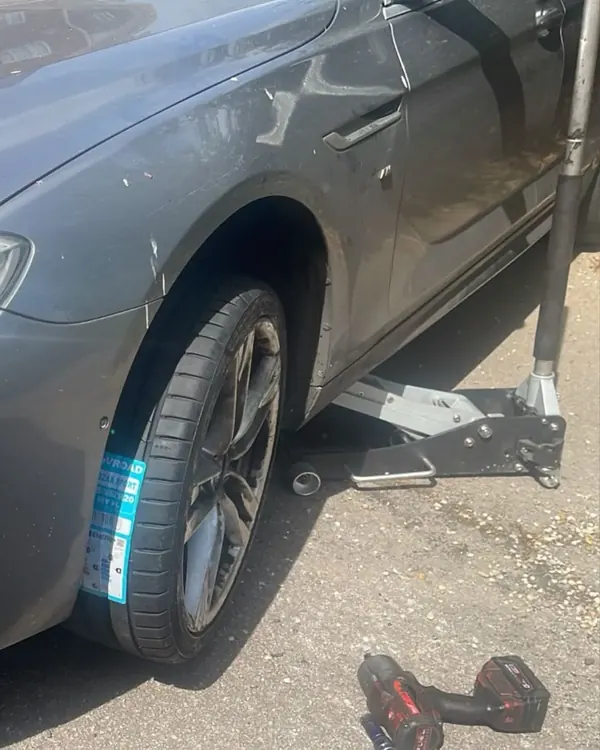 BMW with a new tyre fitted at the kerb